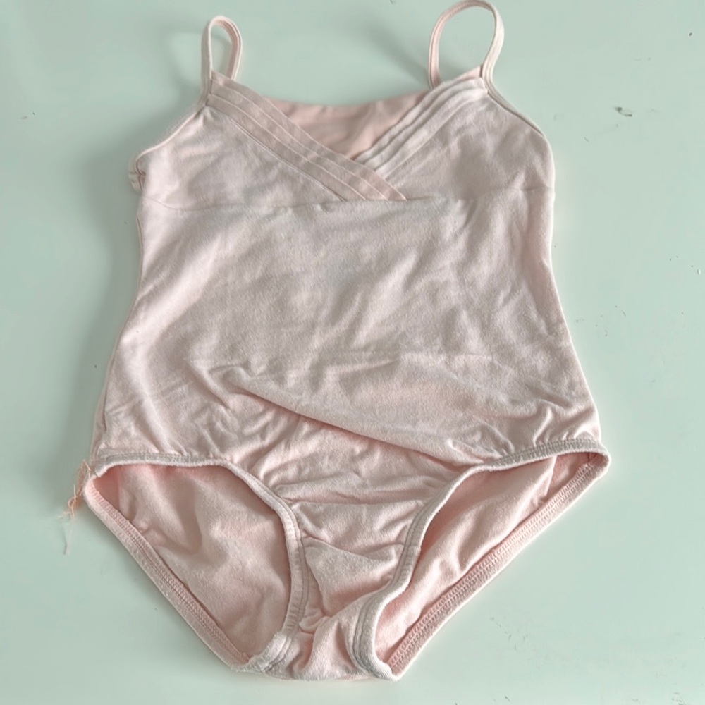More Than Magic pink leotard. Pleated front detail. Full bottom. Size med (7-8)